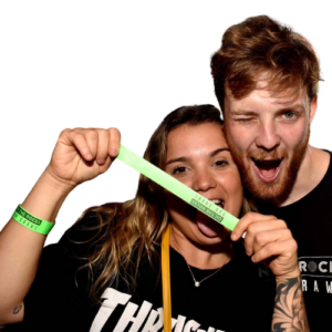 Two people are pulling silly faces whilst holding wristbands for On The Rocks bar crawl Brighton
