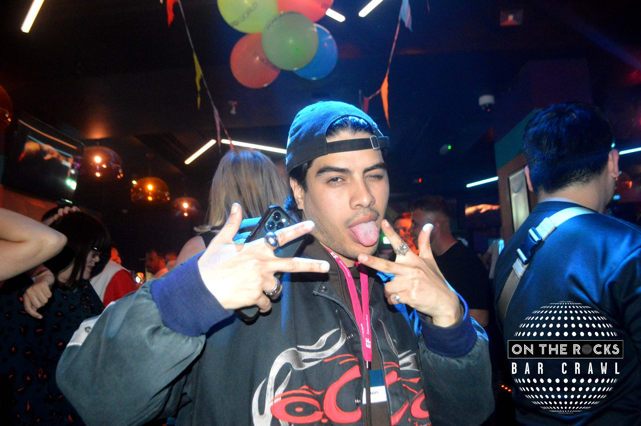 A student group leader poses with his tongue out on a Brighton student bar crawl